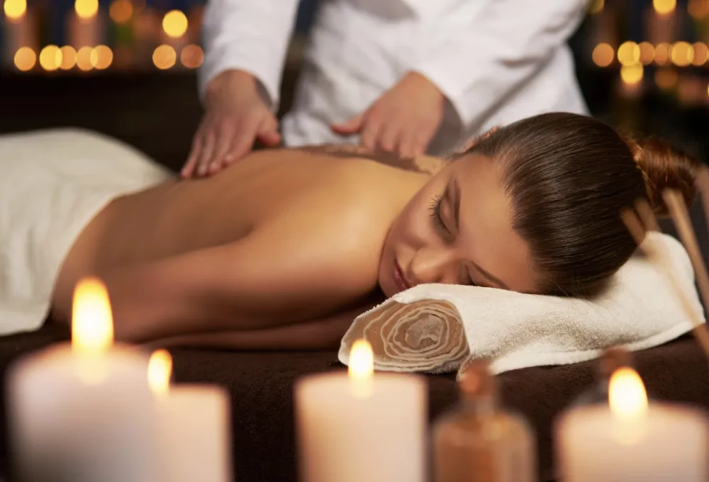 Vrouw die ontspannende massage krijgt met kaarslicht